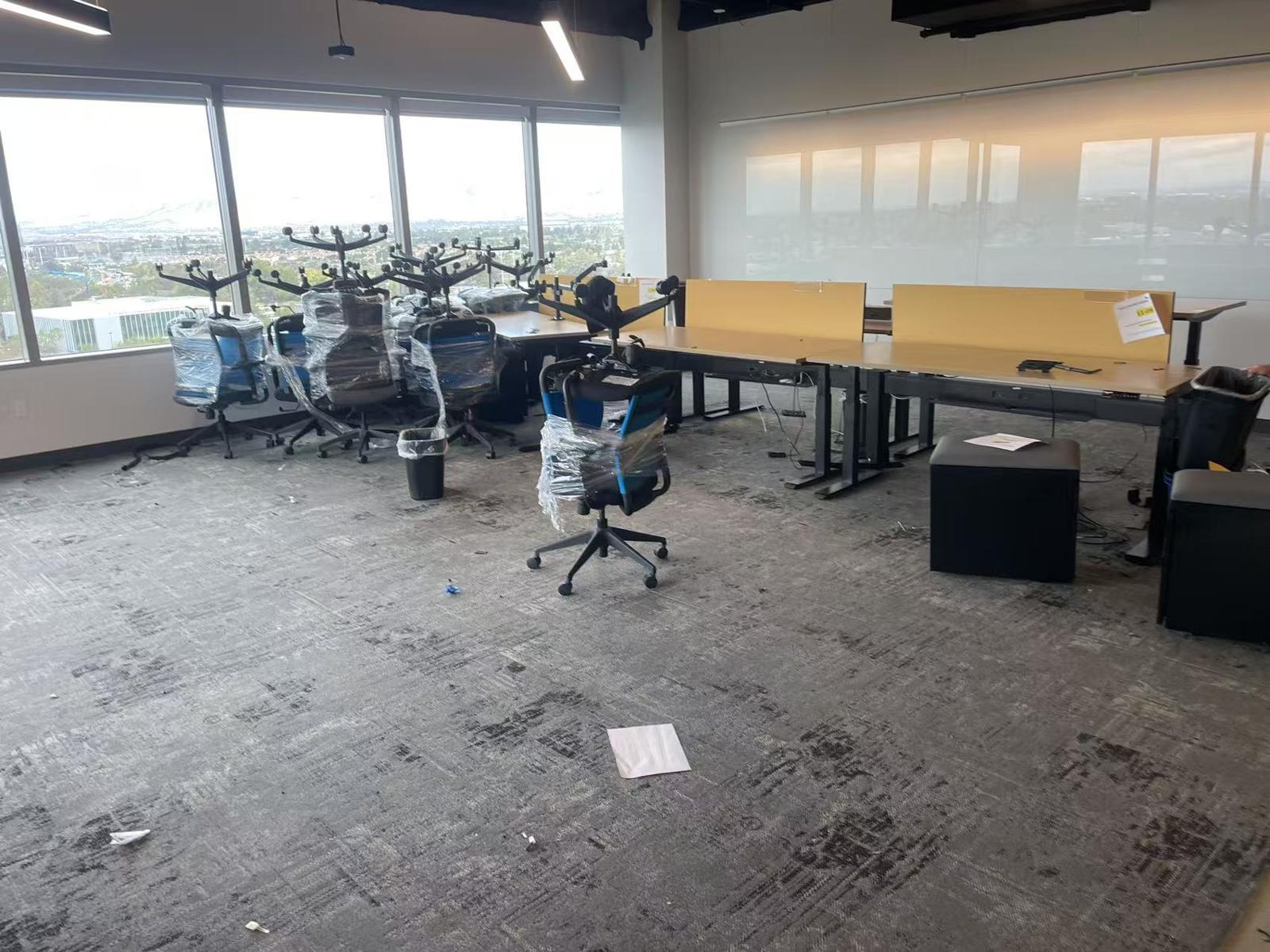 Wrapped office chairs gathered in an open office